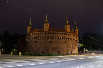 Kraków Barbican by night. Historic fortified gateway of the Old Town of Krakow, Poland.