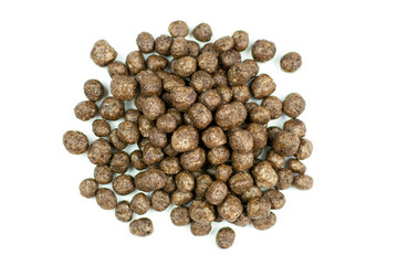 Corn chocolate balls close-up on a white isolated background. Quick healthy breakfast, add milk.