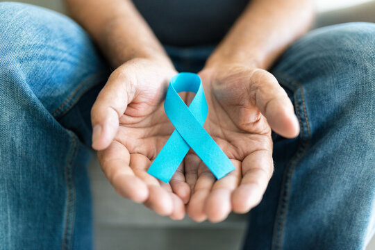 Senior Man Holding A Blue Cancer Awareness Ribbon