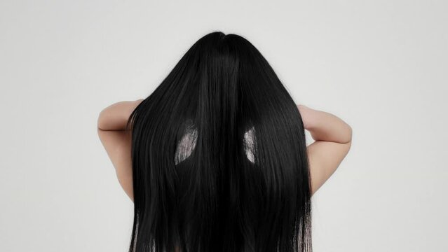 Haircare. Unrecognizable lady brunette waving her healthy long smooth hair, showing result of professional cosmetics