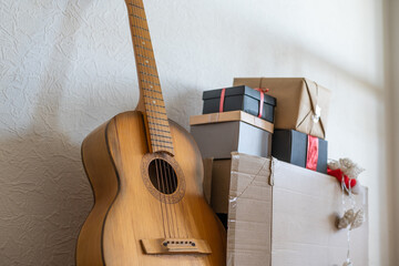 guitar with Christmas presents. Concept image for holiday musical event.