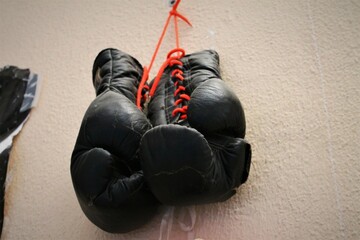 Old vintage boxing gloves on a white background
