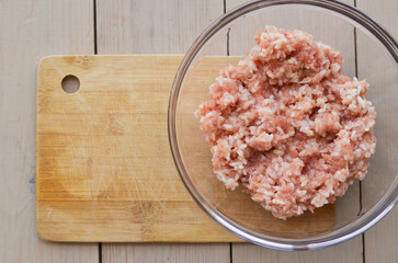 minced rice in a glass dish on a wooden cutting Board top view