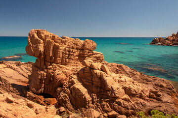 Fototapeta na wymiar Su Sirboni beach, Sardinia. Marina di Gairo. Crystal clear waters with white sand and red rocks and junipers