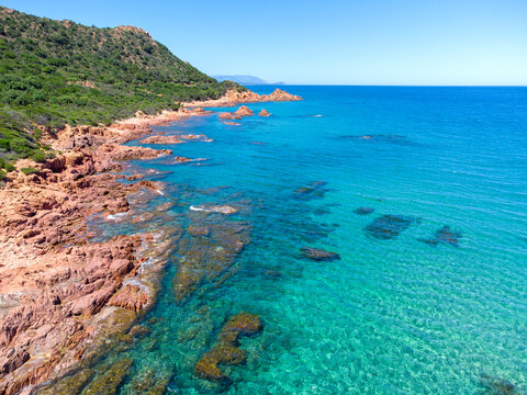 view from the drone of Su Sirboni beach, Sardinia. Marina di Gairo. Crystal clear waters with white sand and red rocks and junipers