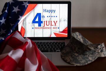 American flags with inscription Happy Independence Day on laptop
