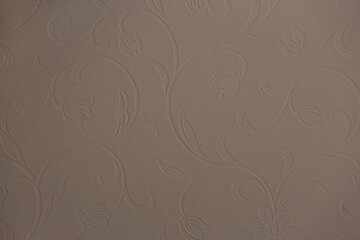 Brown background from decorative plaster with abstract spots. Unusual beige wall texture with beautiful patterns, creative surface background. Front covering for facing of buildings.