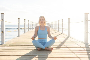 Portrait of fitness woman stretching out by the sea