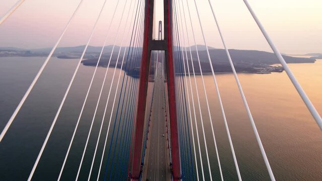 View from above. Russian bridge in Vladivostok across the Eastern Bosphorus. The camera flies between the guys over the roadway.
