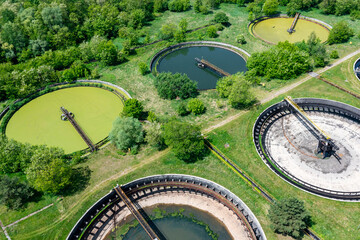 Sewage farm. Aerial photo looking down onto the clarifying tanks and green grass. Top view of sewage treatment plant. Industrial Technology. 