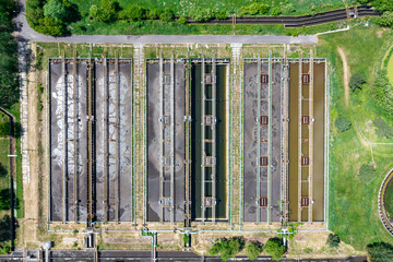 Sewage farm. Aerial photo looking down onto the clarifying tanks and green grass. Top view of sewage treatment plant. Industrial Technology. 