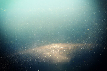 background of abstract glitter lights. gold and blue. de focused