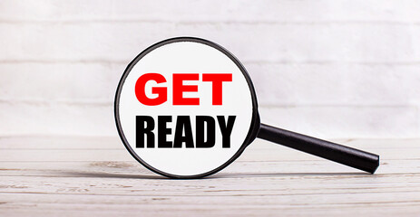 The magnifying glass stands vertically on a light background with the text GET READY