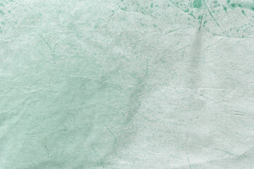 Obraz premium Texture of craft light green old paper, crumpled background. Vintage cyan grunge surface backdrop.
