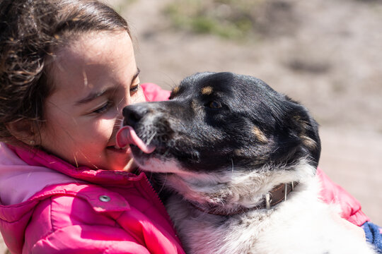 poor little girl with a dog in village