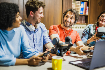 Group of young influencers using their live streaming channel on social media to review new...