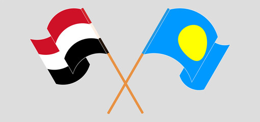 Crossed and waving flags of Yemen and Palau