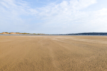 Fototapeta na wymiar Wide angle view of empty beach with expanse of sand
