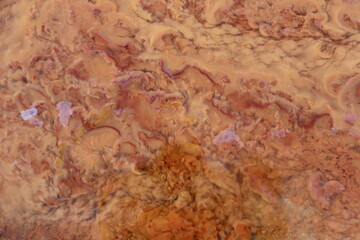 Fototapeta premium orange precipitate which indicates the water contains iron. form a beautiful background.