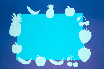 dark blue background with light blue paper with pastel blue fruits on the edges, creative fresh design, summer vitamin refreshment and cool colors