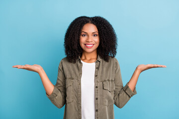 Portrait of attractive cheerful person arms palms hold vs scales solution empty space isolated on...