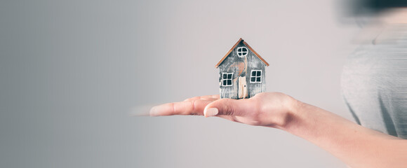 young woman holding a house