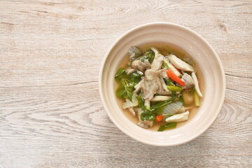 spicy boiled mixed mushroom and basil leaf soup on bowl