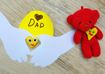 Child making funny crafts, greeting card from paper and clay, plasticine.  Fathers day, Birthday or Valentines day . Arts  crafts concept.