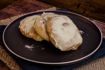 Ensaymada Bread - Filipino bread - isolated on a wooden table, macro details, studio lighting, ample copy space