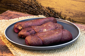 UBE Spanish bread - Isolated on wooden background with ample copy space, studio. lighting