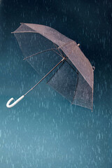transparent umbrella with blue background and rain
