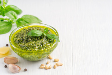 Traditional homemade herbal italian pesto sauce made of blended green basil leaves, pine nuts,...