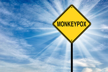 Monkeypox. Road warning sign with the word Monkeypox against the sky.