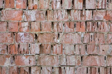 Badly damaged brick wall. Background texture.