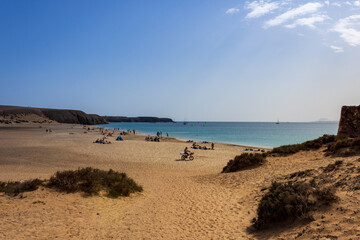 Panoramic view of Playa Mujeres beach with Atlantic Ocean and surrounding arid landscape at the Papagayo coast of Playa Blanca, Lanzarote, Canary Islands,Spain.