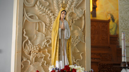 Statue of the Virgin Mary standing indoors