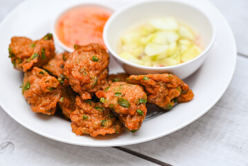 fish cakes on white plate , fried fish paste balls with sauce - Asian Thai food