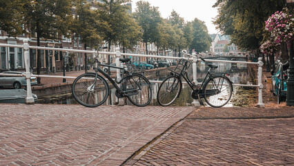 Bicycles parked on a bridge and typical Dutch houses in Leiden, Netherlands