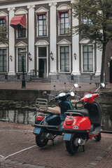 Red and blue scooter parked in Leiden - 508235613