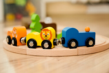 Wooden railway and train with animal wagons on wooden floor. Nostalgia toy from childhood.