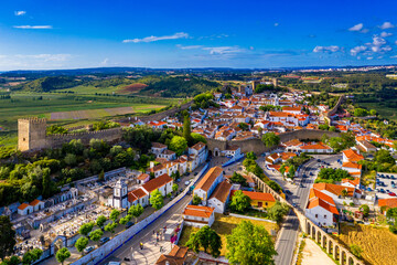 Aerial view of the historic walled town of Obidos at sunset, near Lisbon, Portugal. Aerial shot of Obidos Medieval Town, Portugal. Aerial view of medieval fortress in Obidos. Portugal.