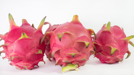 RED PITAHAYA DRAGÓN FRUIT ON A WHITE BACKGROUND WITH SPACE FOR TEXT, HEALTHY DIET WITH EXOTIC...