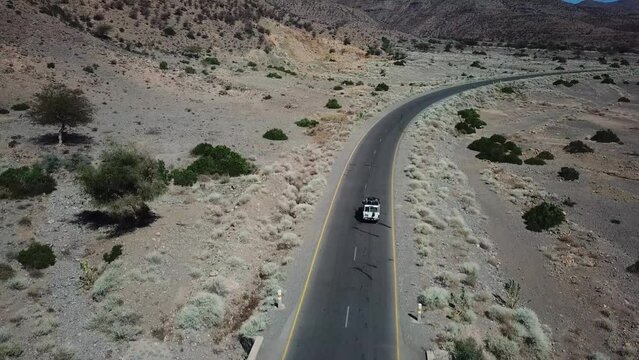 Drone view of jeep driving on road in Africa. Ethiopian mountain ranges. Hot climate