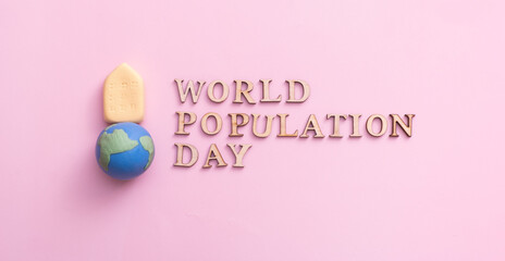 Fototapeta na wymiar World population day write by wooden letter with globe and small house