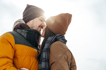 Fototapeta premium Young couple in love outdoor in snowy winter forest.