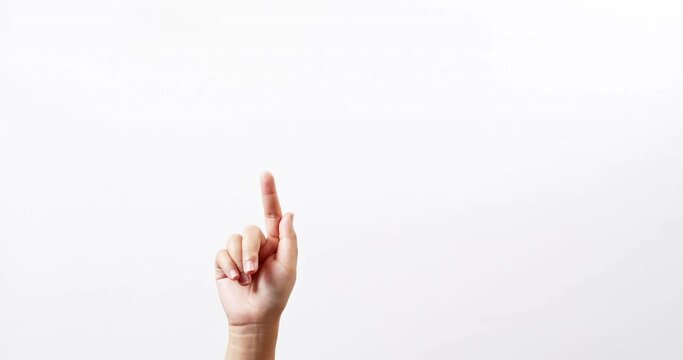 Close up of a woman making gestures with one arm with touching on a white studio background with copy space for placing a text for an advertisement.