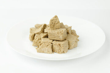 Pieces of oriental halva on a white plate.