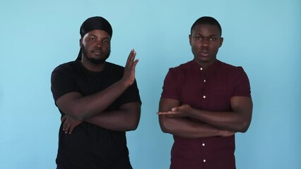 Man friendship. High five. Teamwork support. Boomerang motion. Serious best friends Afro black buddies with greeting deal gesture isolated on blue background GIF loop animation.