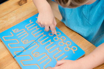 Obraz premium Hand writing training board. Children home activity. Early education, fine motoric skills, learning to write. Primary school exercises.