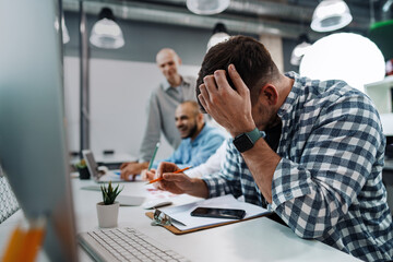 Group of young business people working in office together